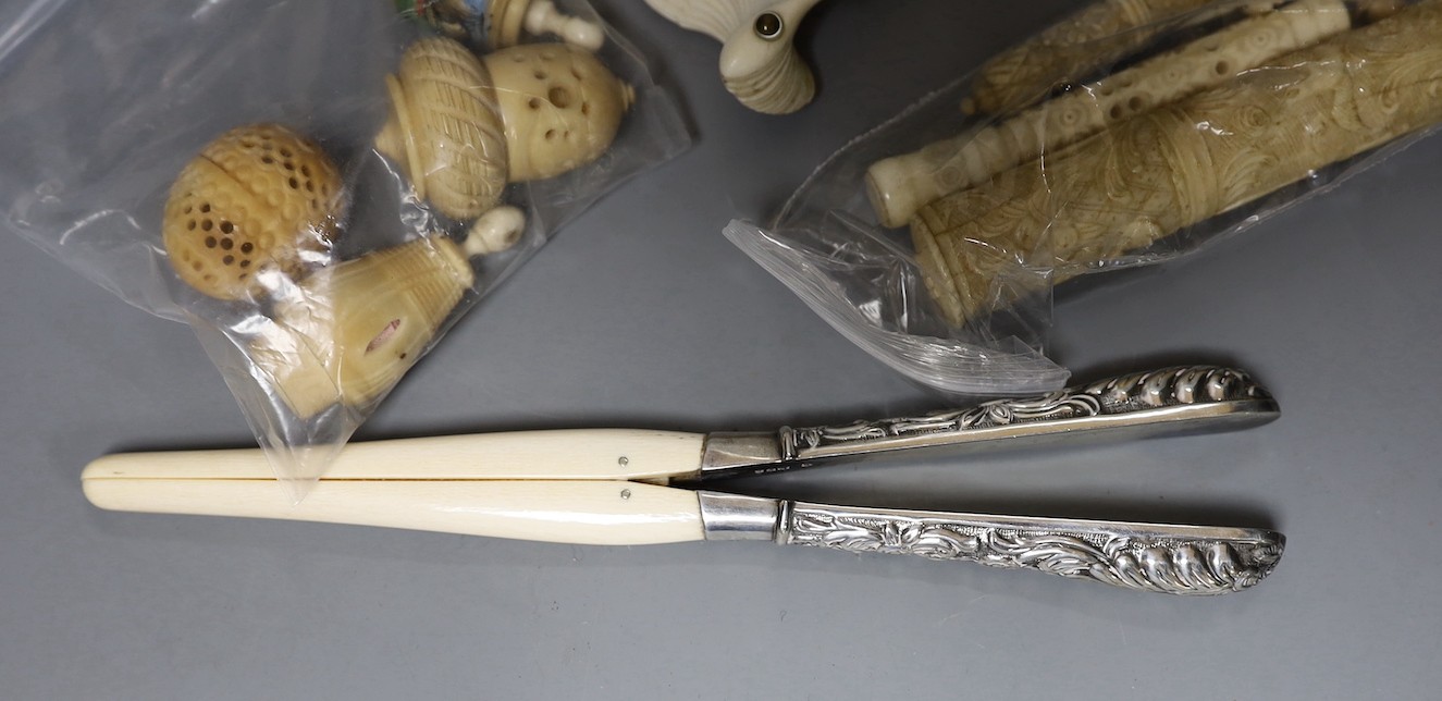 A mix collection of antique ivory to include needle cases, silver mounted gloves stretcher, etc and nut sewing accessories